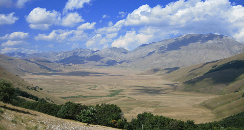 Il borgo di Castelluccio di Norcia sul colle, affacciato sui Piani e sul Monte Vettore